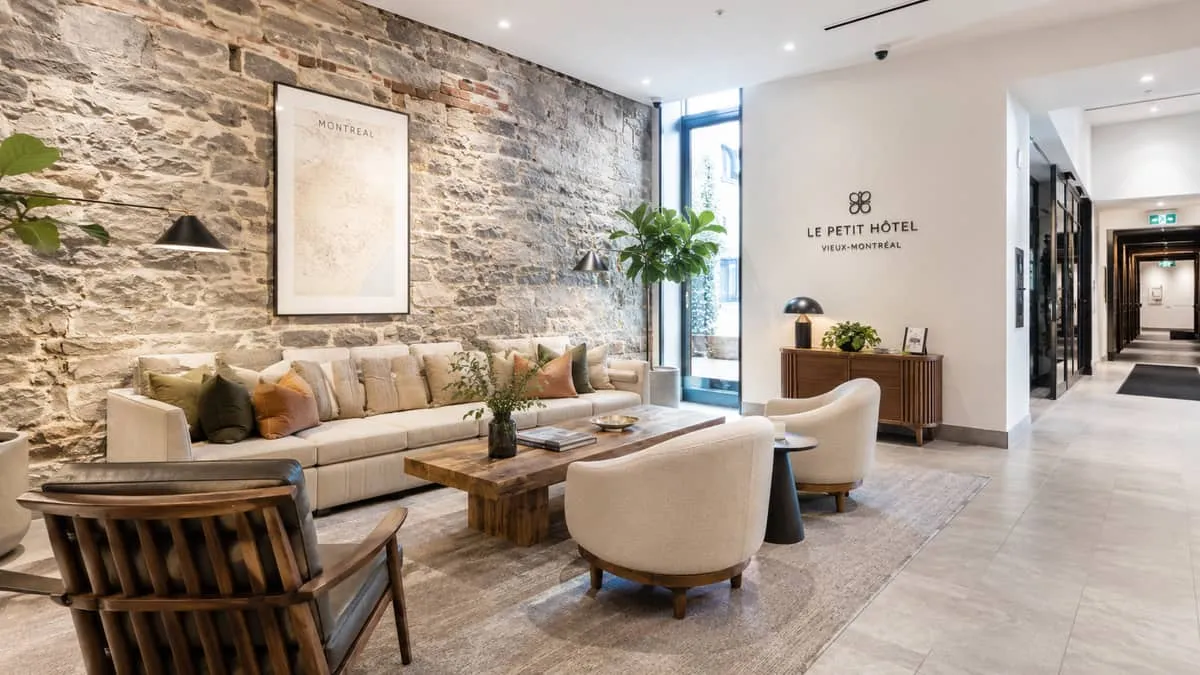 a hotel lobby or lounge corner showing a mix of locally sourced wood pieces and upholstered seating in a Montreal boutiq