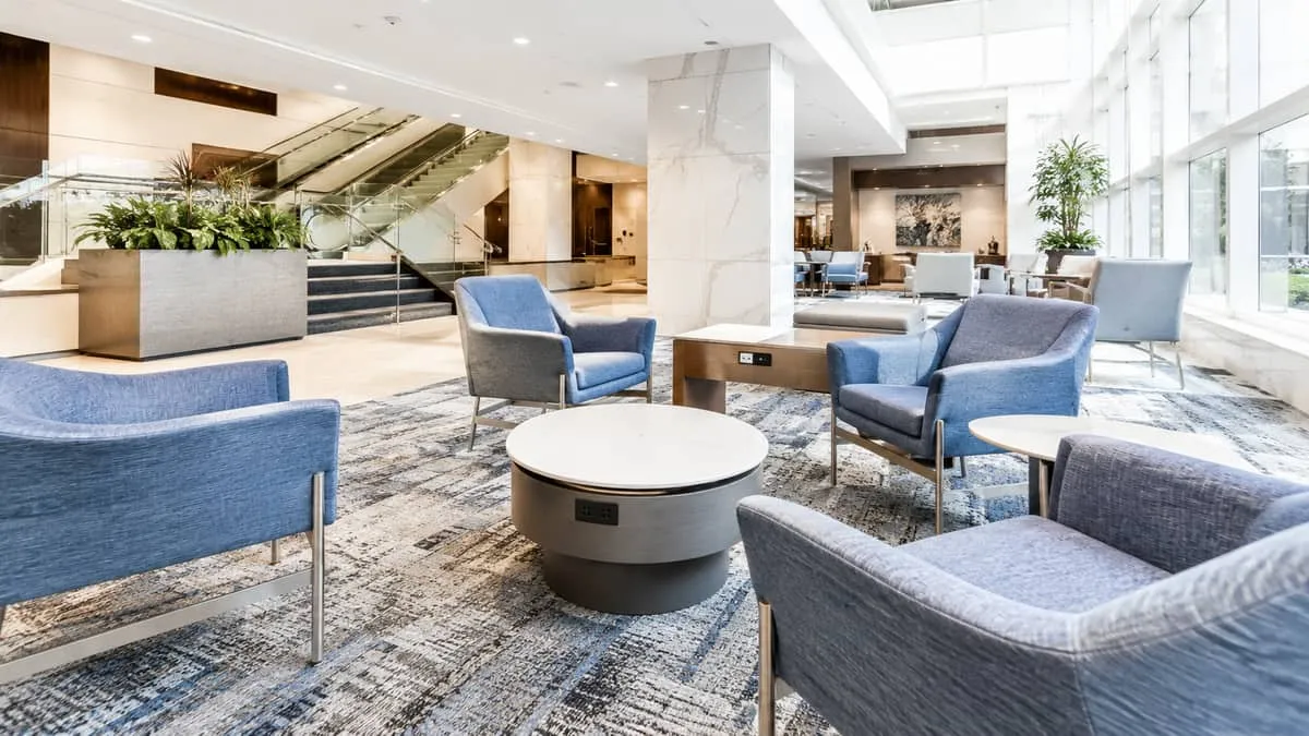 hotel lobby seating area near a conference center showing practical cluster arrangement with visible power access points