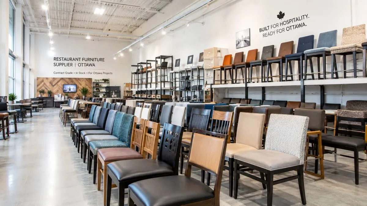 a furniture supplier showroom with commercial hotel furniture on display, including upholstered headboards, case goods, 