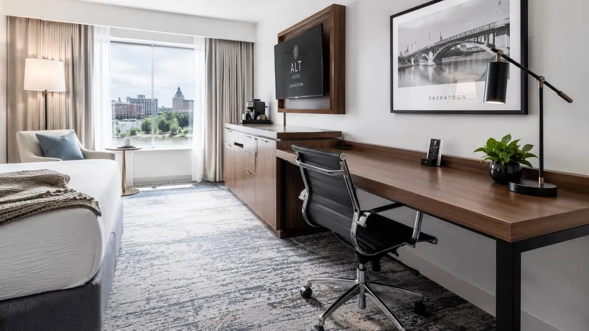 a hotel room work desk and chair setup in a boutique Saskatoon property, showing contract-grade desk chair and solid woo