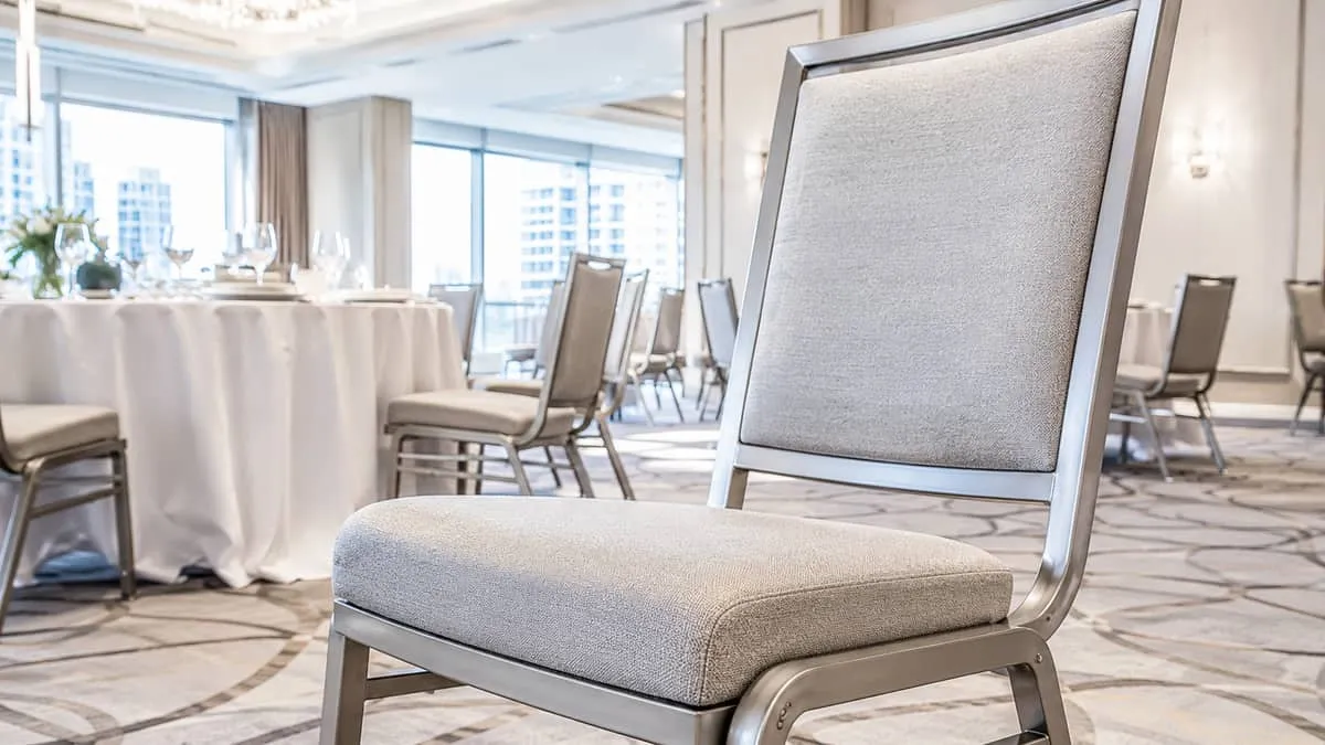 close-up of a padded banquet chair showing the frame construction, seat padding, and fabric finish suitable for a Toront