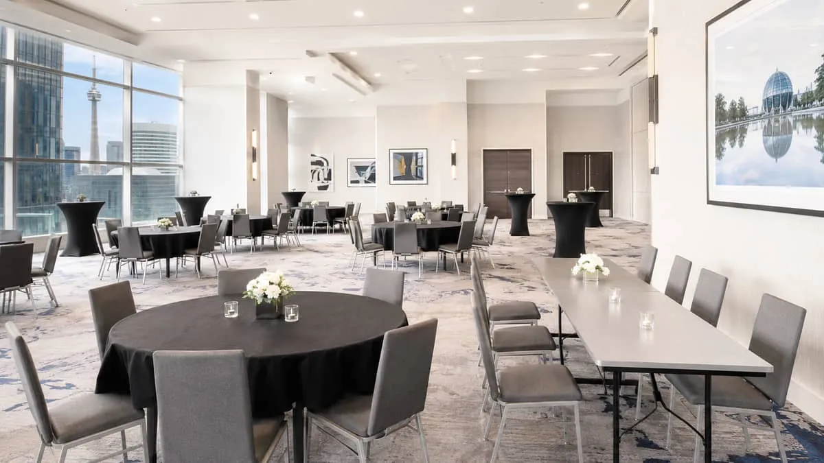 a mix of round and rectangular folding banquet tables in a Toronto convention or hotel setup, showing different table he