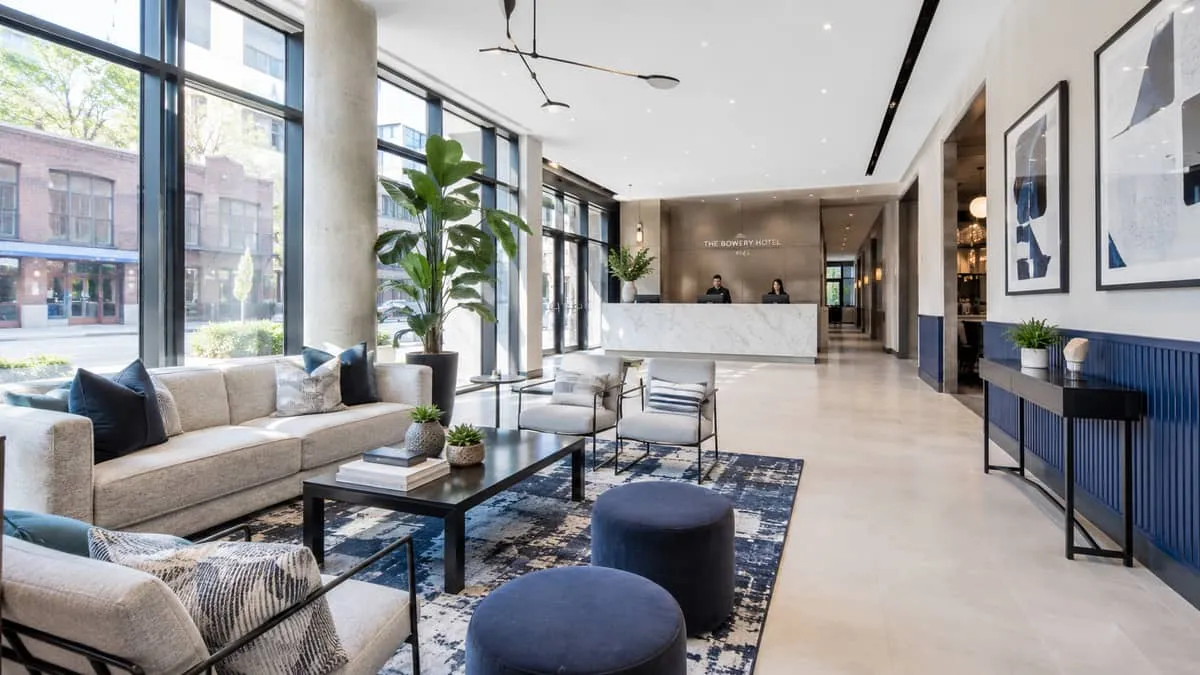 polished full lobby shot of a mid-to-upscale Toronto hotel interior with cohesive furniture selections throughout, recep