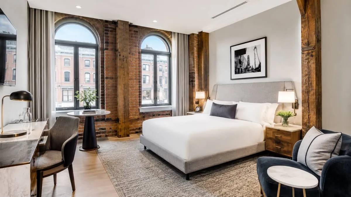 boutique hotel guestroom in a heritage Toronto building showing carefully selected FF&E pieces that complement the origi