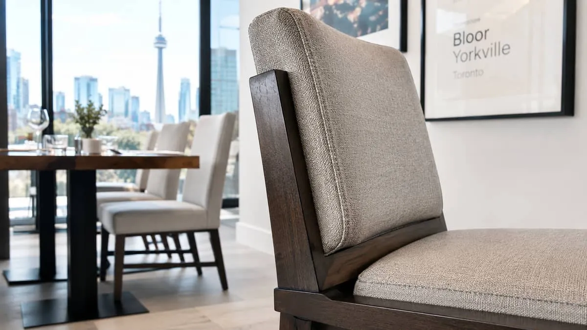 close-up of a contract-grade restaurant chair showing reinforced joinery and commercial upholstery fabric, with a Toront