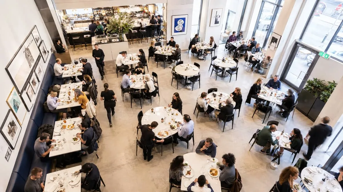 overhead shot of a Toronto restaurant dining room with round and rectangular HPL-top tables paired with contract-grade s