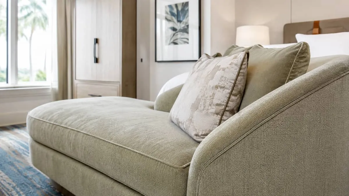 close-up of custom upholstered boutique hotel seating in a warm, muted palette with natural textures, contract-grade sti