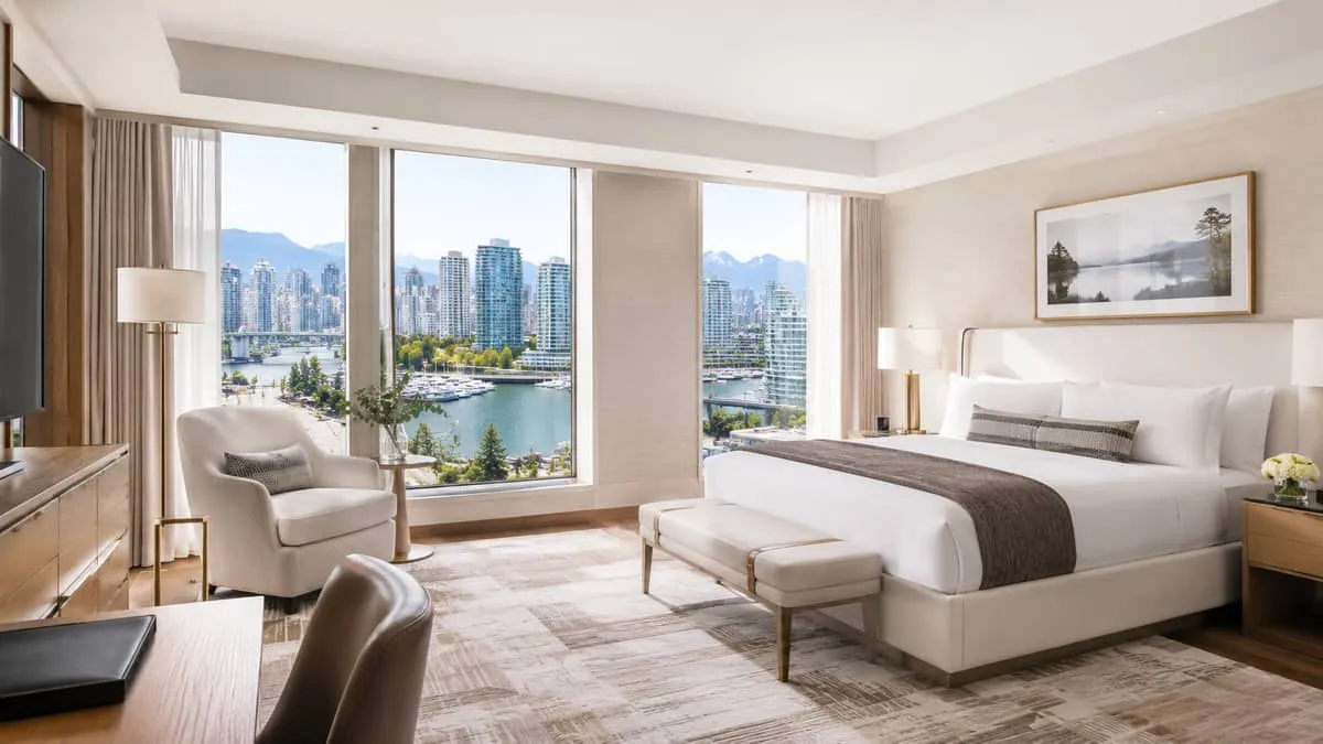 boutique hotel suite interior in Vancouver showing a cohesive furniture arrangement mixing a statement lounge chair, cas