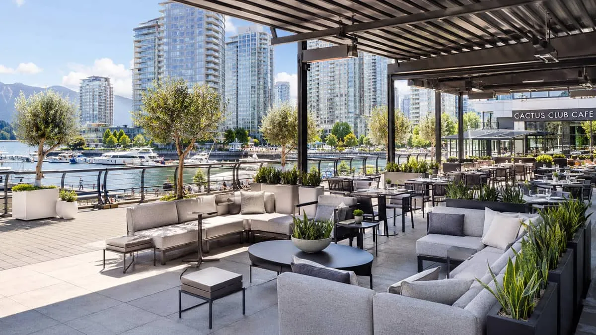 a Yaletown or Coal Harbour restaurant patio scene showing a cohesive furniture program with modular seating, matching si