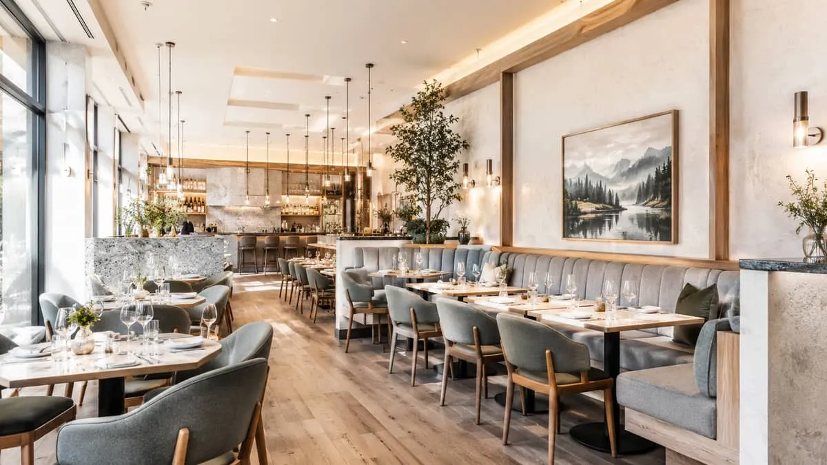 interior shot of a Vancouver-style upscale restaurant showing custom millwork banquettes alongside freestanding chairs a