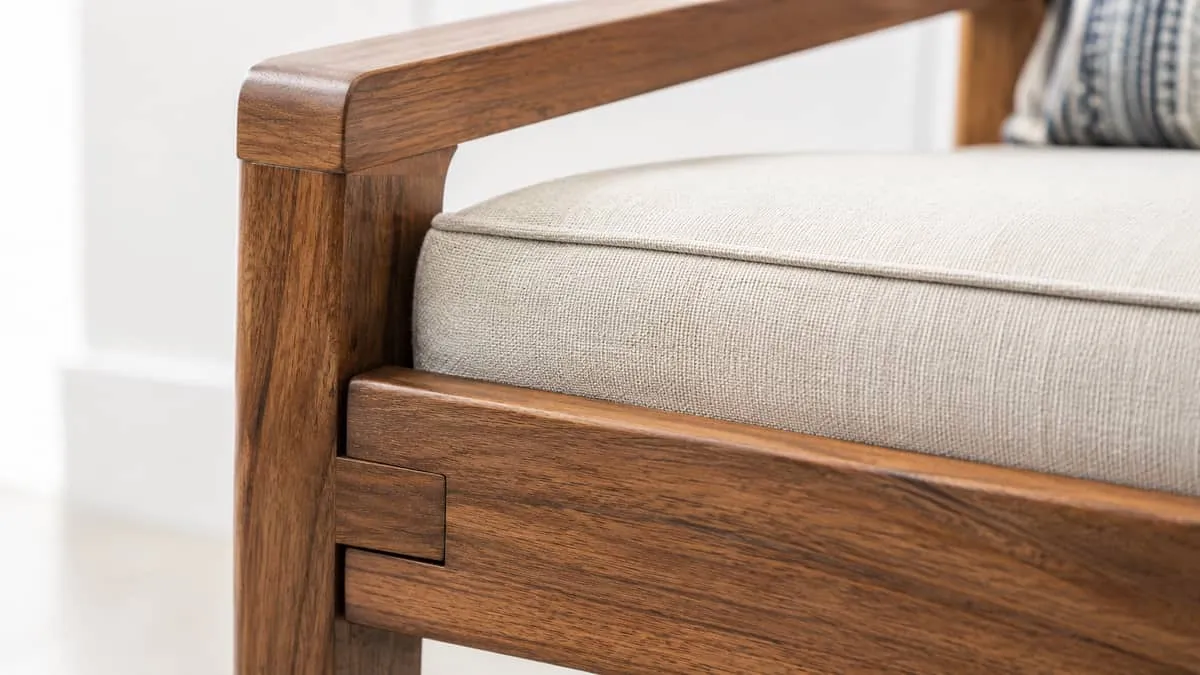 close-up detail shot of high-quality contract furniture construction, showing joint detail, fabric or leather upholstery