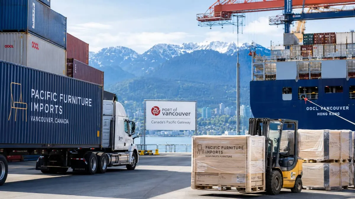 a container or freight logistics image representing furniture import at the Port of Vancouver, with mountains visible in