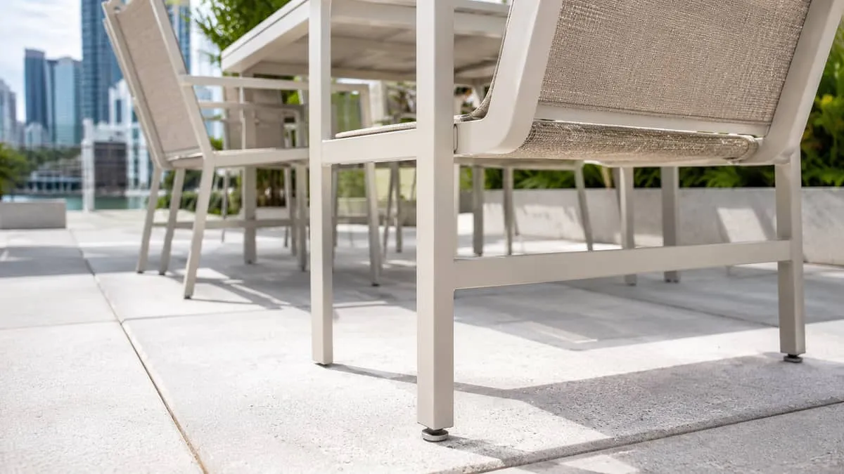 Recycled plastic and metal-frame picnic tables on a commercial patio