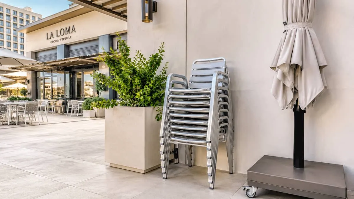Atlanta hotel pool deck furniture showing commercial-grade aluminum loungers and dining chairs in cohesive Buckhead property program built for eight-year lifecycle