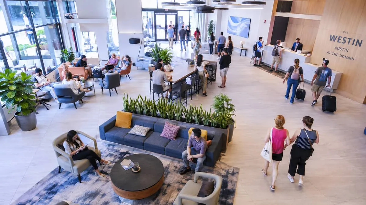 Downtown Greensboro hotel lobby furniture showing contract-grade lounge seating cluster with high-resilience foam and commercial-rated upholstery for high-volume guest traffic